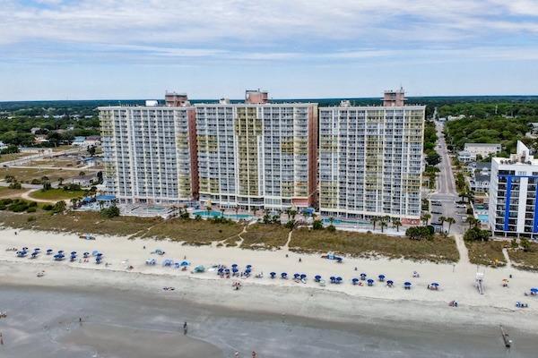 Aerial view of Bay Watch Resort’s oceanfront towers and beach in North Myrtle Beach, South Carolina.