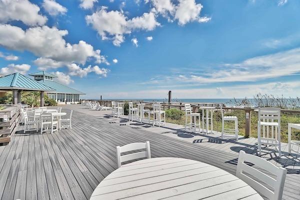 Oceanfront seating area with tables overlooking the beach in Litchfield Beach, South Carolina.