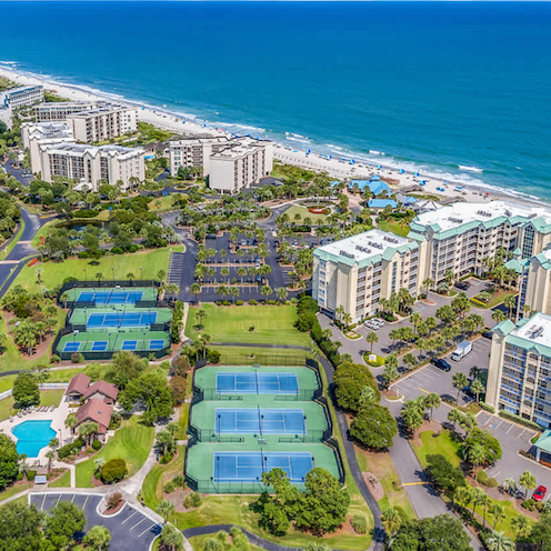 Aerial view of Litchfield by the Sea featuring oceanfront condos, tennis courts, and private beach access